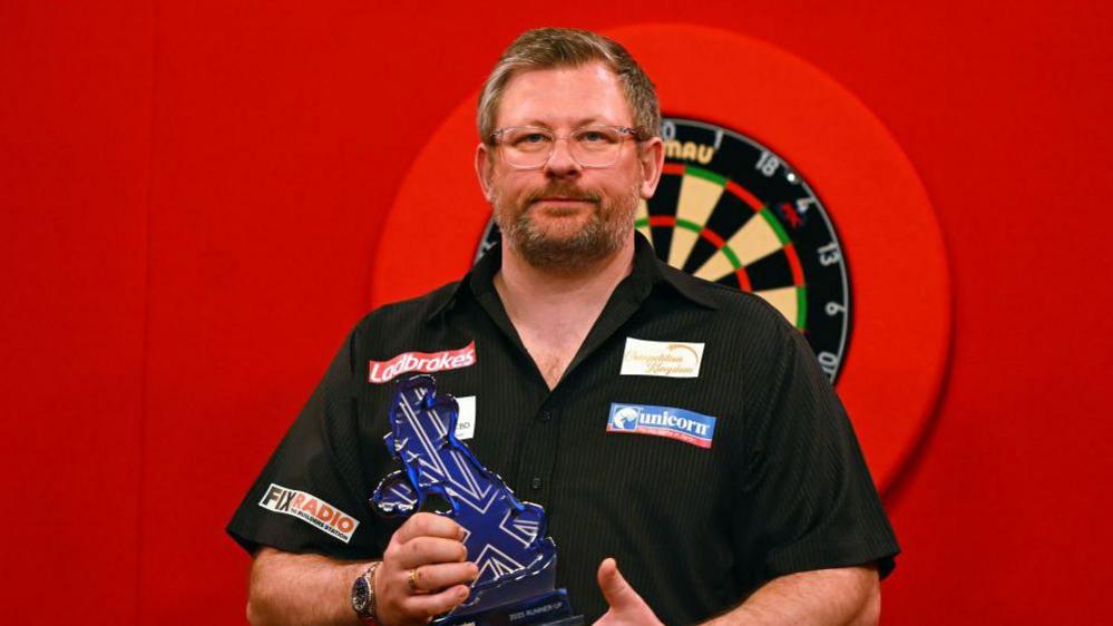 James Wade holding the UK Open runner-up trophy