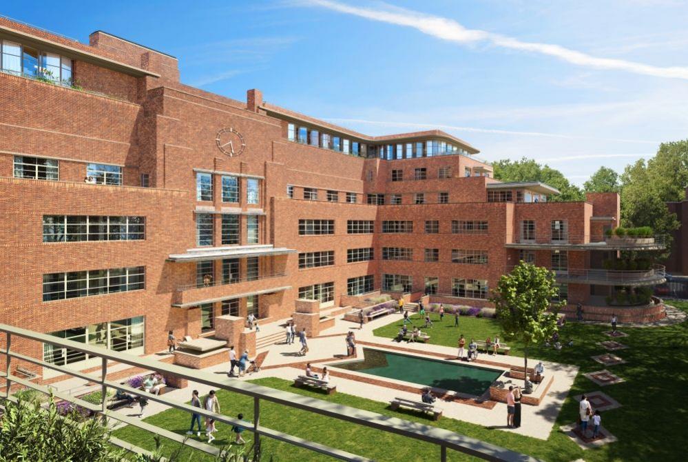 A computer-generated image of the proposed redevelopment. The main building is viewed from the side from a balcony on the third storey of the left of the building. The front and right side of the large red-brick building is visible, with windows on each storey and tall glass windows and doors running along the top of the building. The building descends to three storeys on the right of the building, with a curved balcony on the side. There is a clock at the top of the middle of the building. A grassy courtyard is in the middle of the three-sided building, with cream-coloured paths in front of the building and surrounding a small pool of blue water at the front. There is a small leafy tree in the middle of the courtyard. Pedestrians are walking and sitting around in the courtyard.