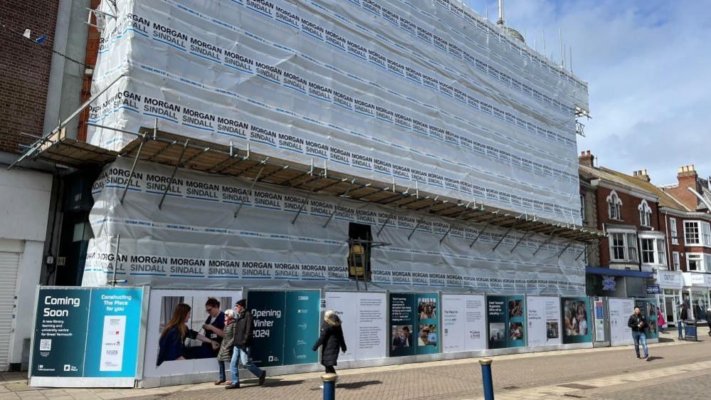 Scaffolding and sheeting surrounds the former Palmers store