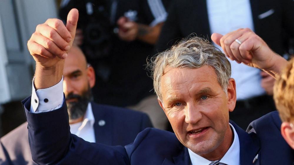 Top candidate of the far-right AfD (Alternative for Germany) party for regional elections in Thuringia Björn Höcke (L) casts his ballot at a polling station in Bornhagen