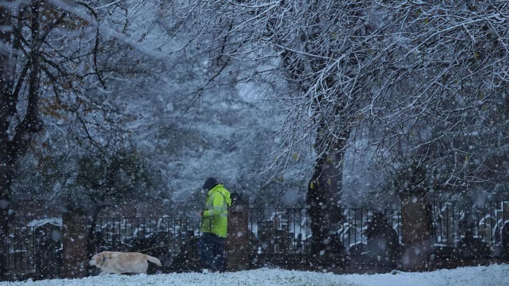 Person walking in the snow in Warwick