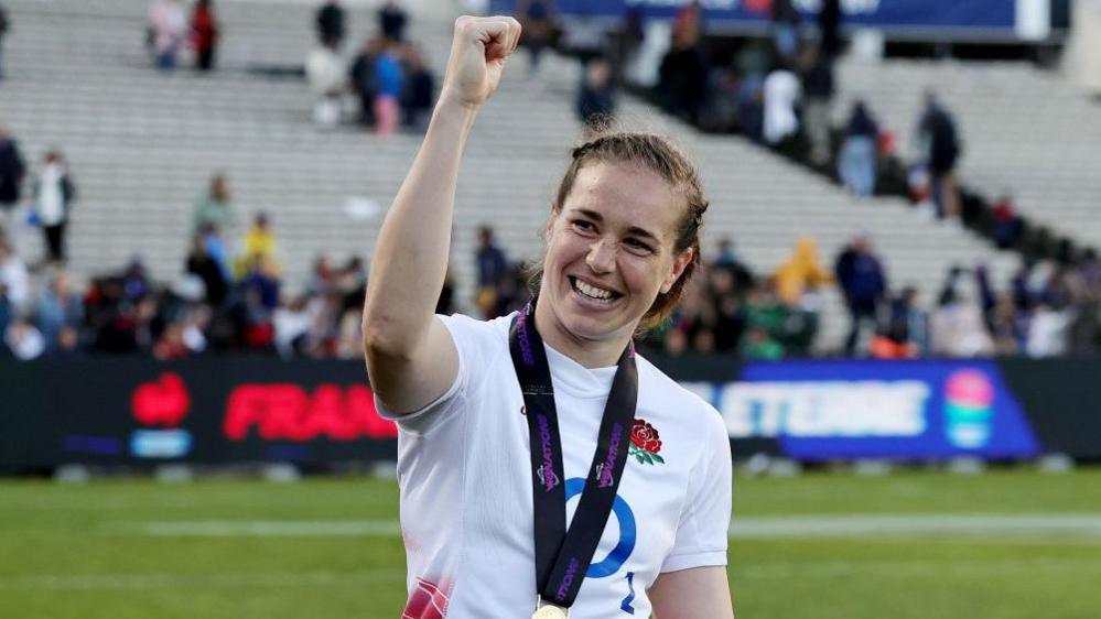 Emily Scarratt celebrates in an England shirt