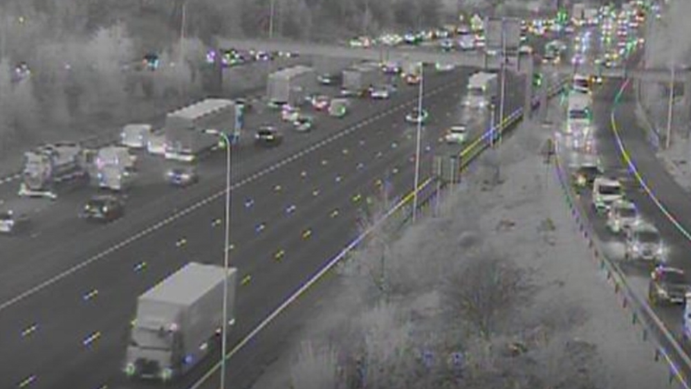A black-and-white motorway camera image of traffic building up.