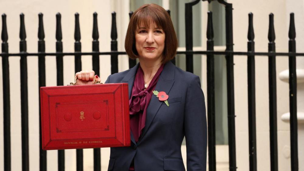 Rachel Reeves poses with the red budget box outside her office on Downing Street in London