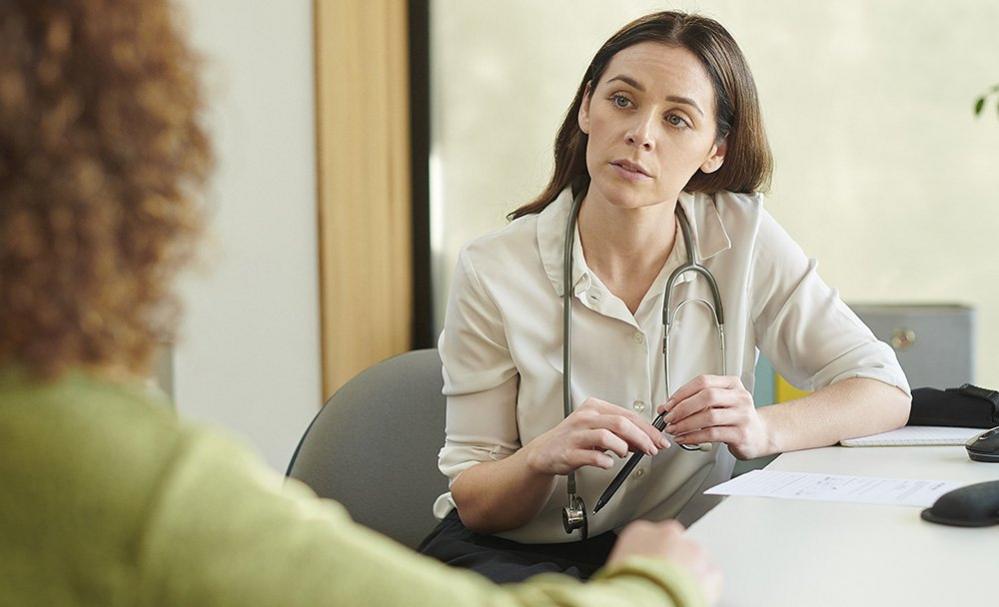 Female specialist consultant listening to patient in the hospital