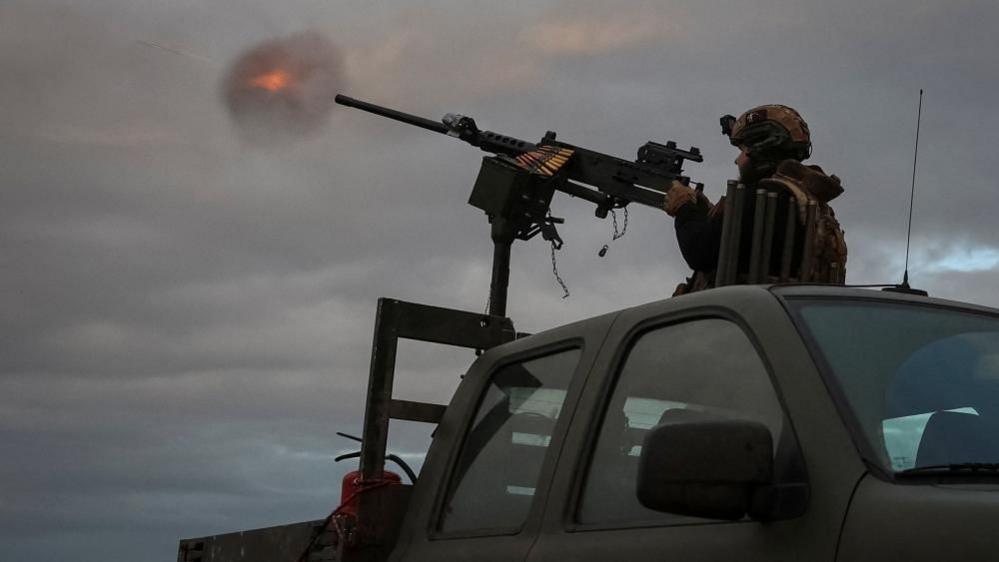 Ukrainian servicemen from an anti-drone mobile air defence unit fire a M2 Browning machine gun during combat shift on the front line in the Donetsk region