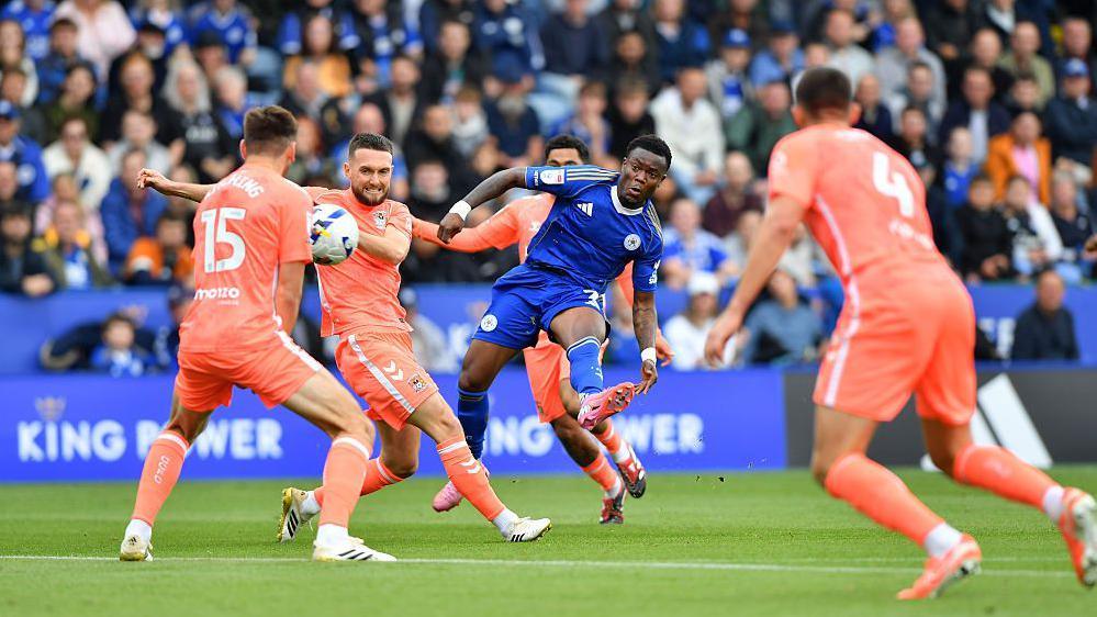 Abdul Fatawu takes a shot for Leicester against Coventry