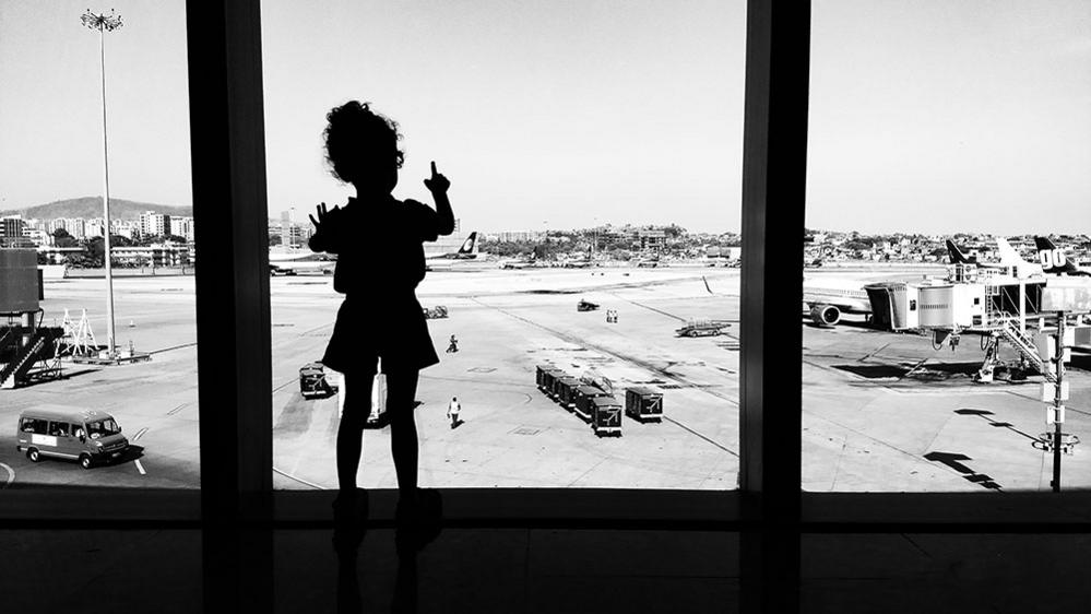 Girl at a window in an airport