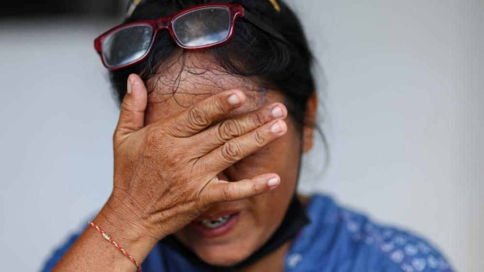 A family member of a victim crying