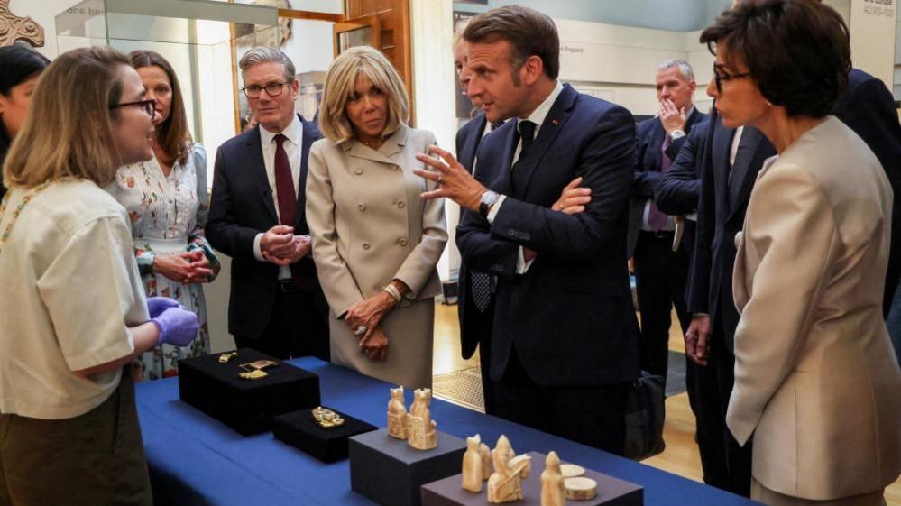 Sir Keir Starmer, France's President Emmanuel Macron, his wife Brigitte Macron and France's Minister of Culture Rachida Dati stand next to the Lewis chessmen in the British Museum