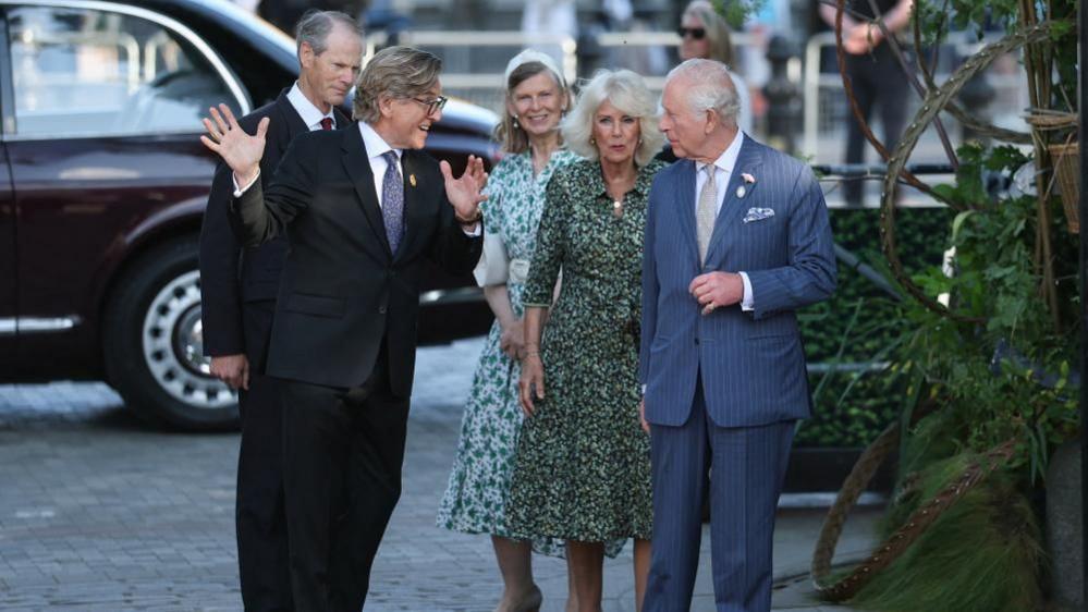 King Charles, patron of the Royal Horticultural Society, and Queen Camilla are met by Keith Weed, president of the RHS, as they arrive to visit the Chelsea Flower Show