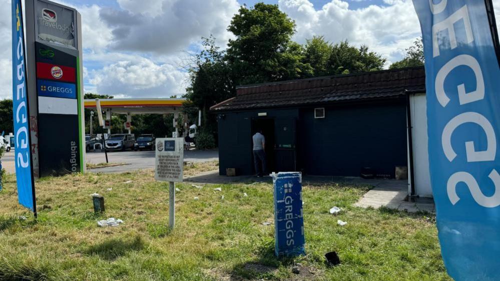 Signs for Greggs and Burger King at the scene of the fire