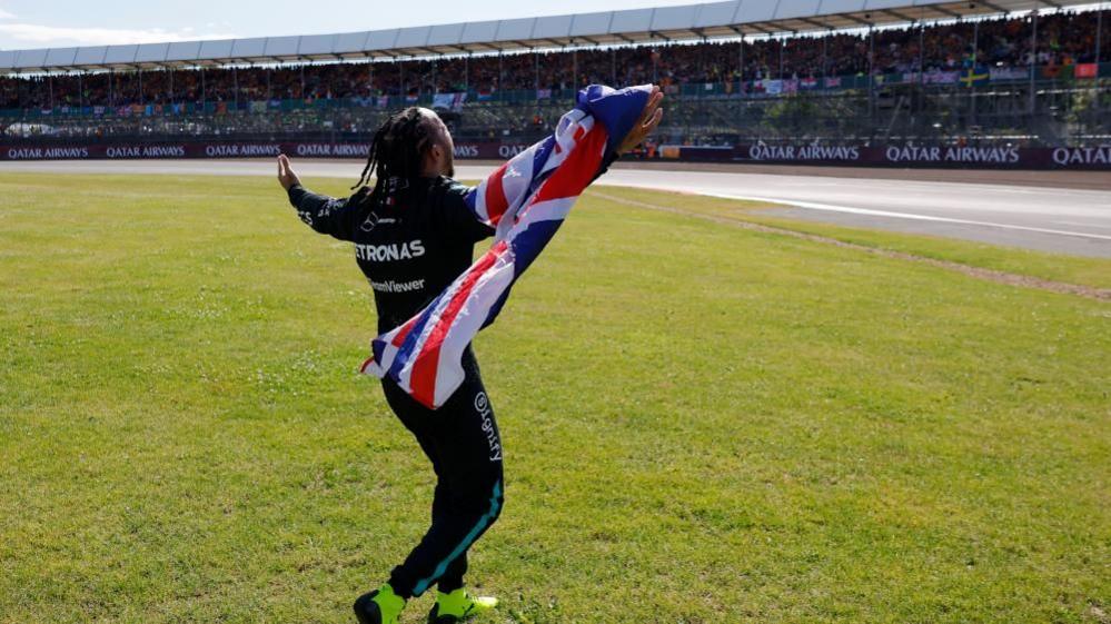 Lewis Hamilton celebrating with the British flag