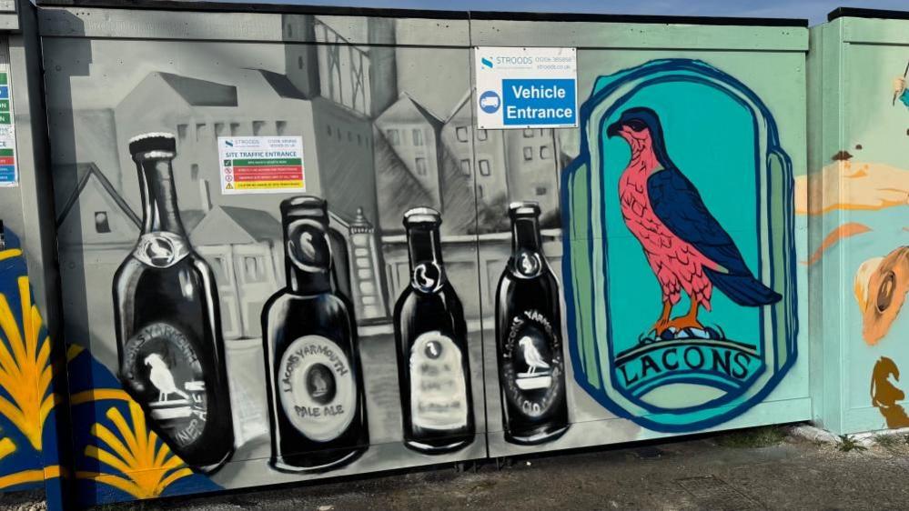 The Lacons falcon is painted on the hoarding, captured along with bottles of Lacons beers. There is also black and white paintings of brewery buildings.