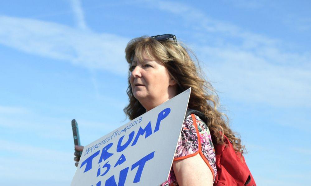 janey godley holding a placard during a famous protest against Donald Trump