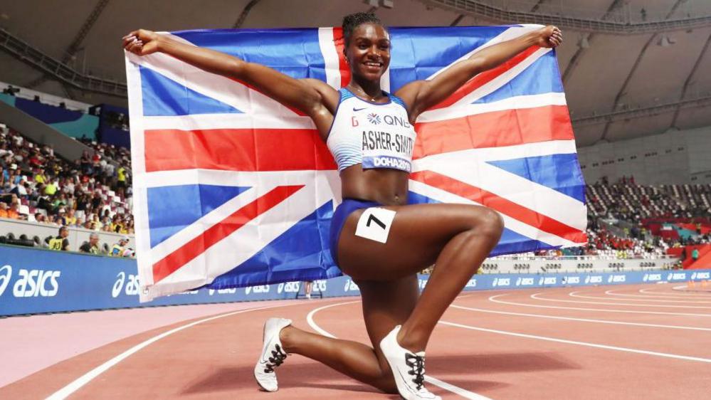 A picture of Dina Asher-Smith with a Union Jack flag