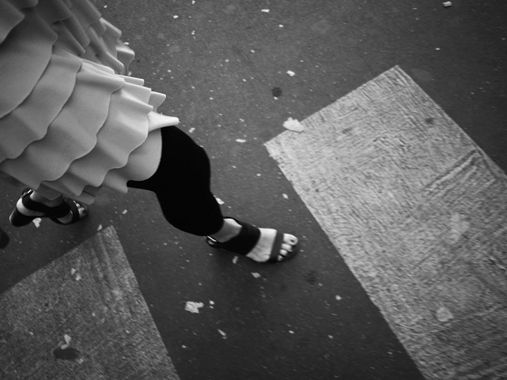 Woman crossing the road in Paris, France