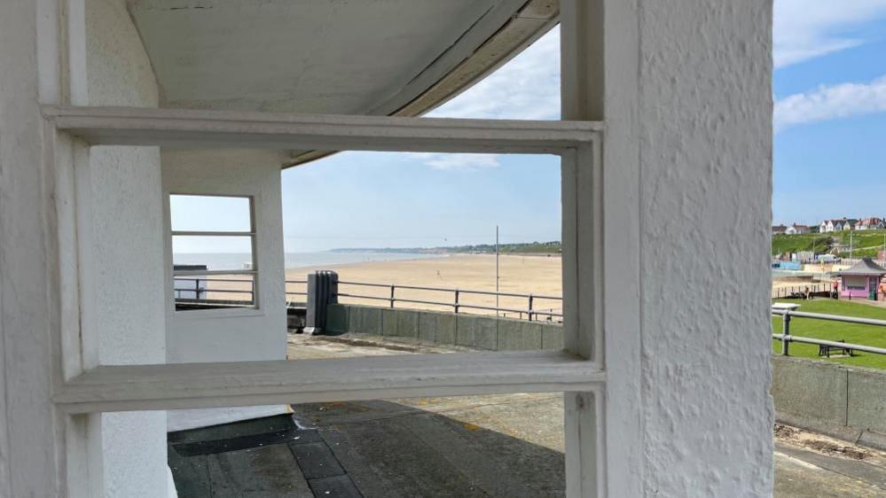 The Ocean Room, viewed from its roof terrace. It features 1930s Art Deco window features and overlooks the beach to the centre.