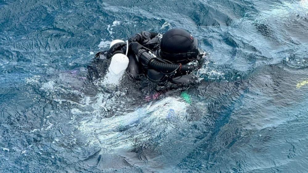A diver from Finland takes part in a recovery operation for four missing Italian scuba divers who died in an accident in underwater caves near Vaavu Atoll, Maldives