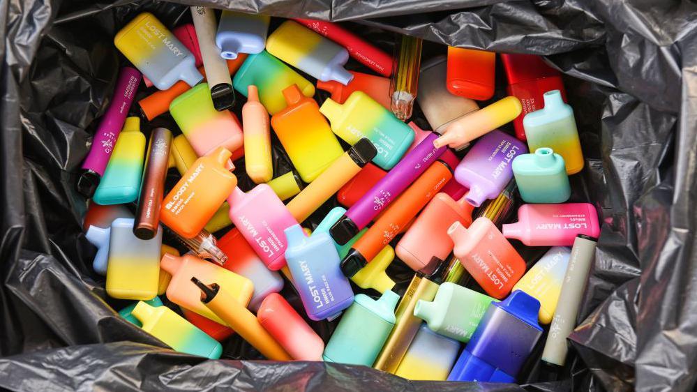 Discarded disposable vapes in a bin