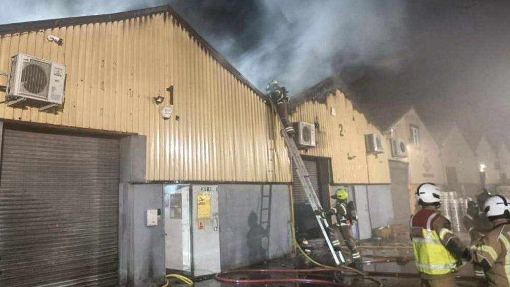 Firefighters tackling a blaze at a Warehouse 