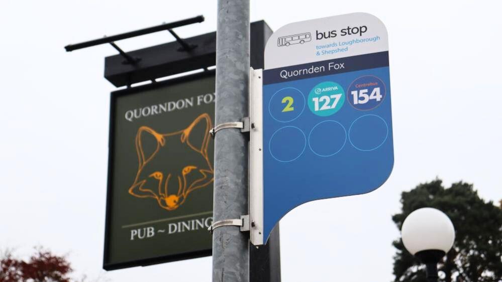 A photo of a bus stop in Quorn, with Quorndon Fox misspelt as Quornden Fox