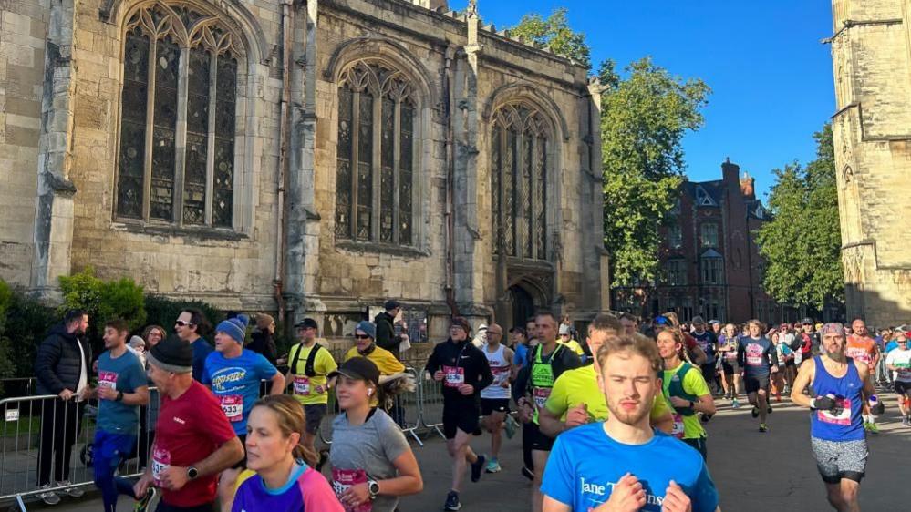 Runners run past York Minster