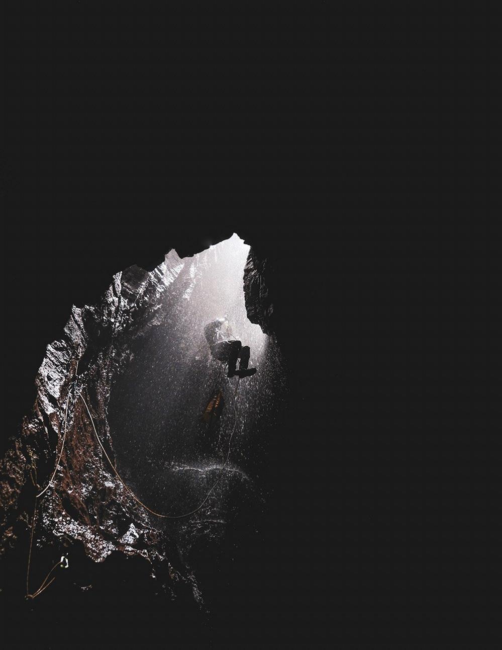 Caver descending into a cave