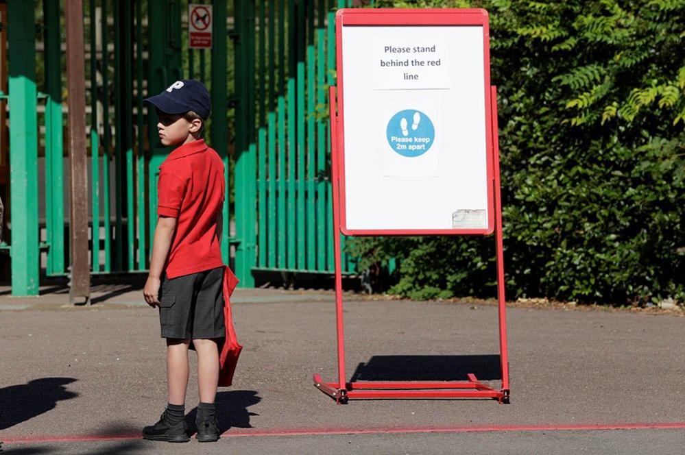 A child waits to enter the school