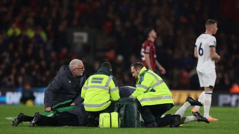 Paramedic treat football lying on floor