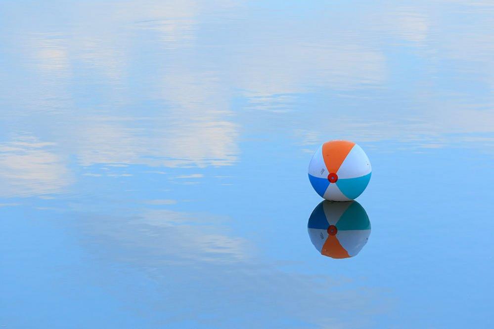 Beach ball on wet sand