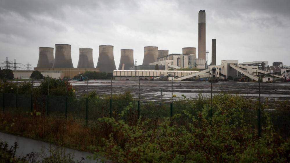 A long distance view of Ratcliffe-on-Soar power station, showing the former coal heap in the foreground.