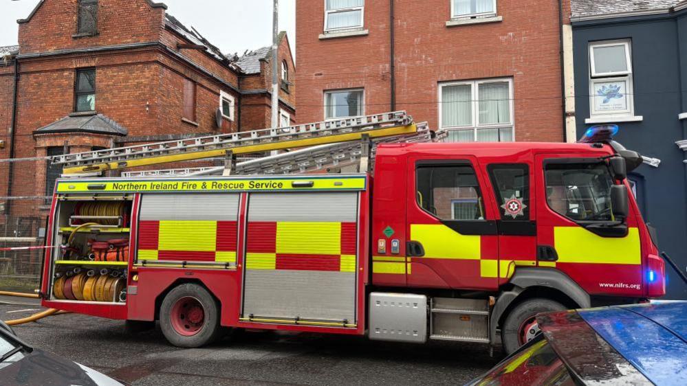 A fire appliance parked outside the affected building. 