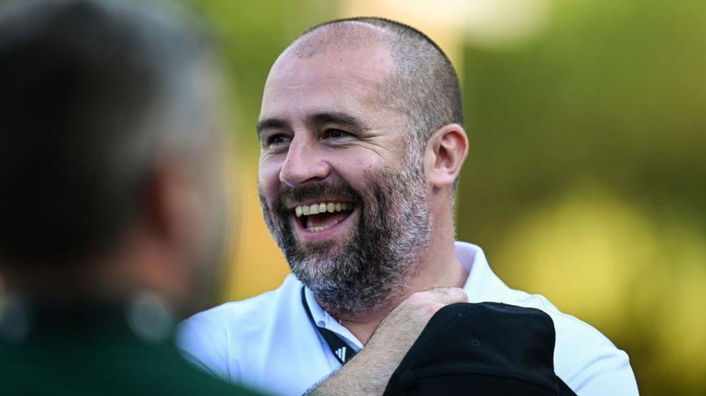 Paul Mitchell smiles