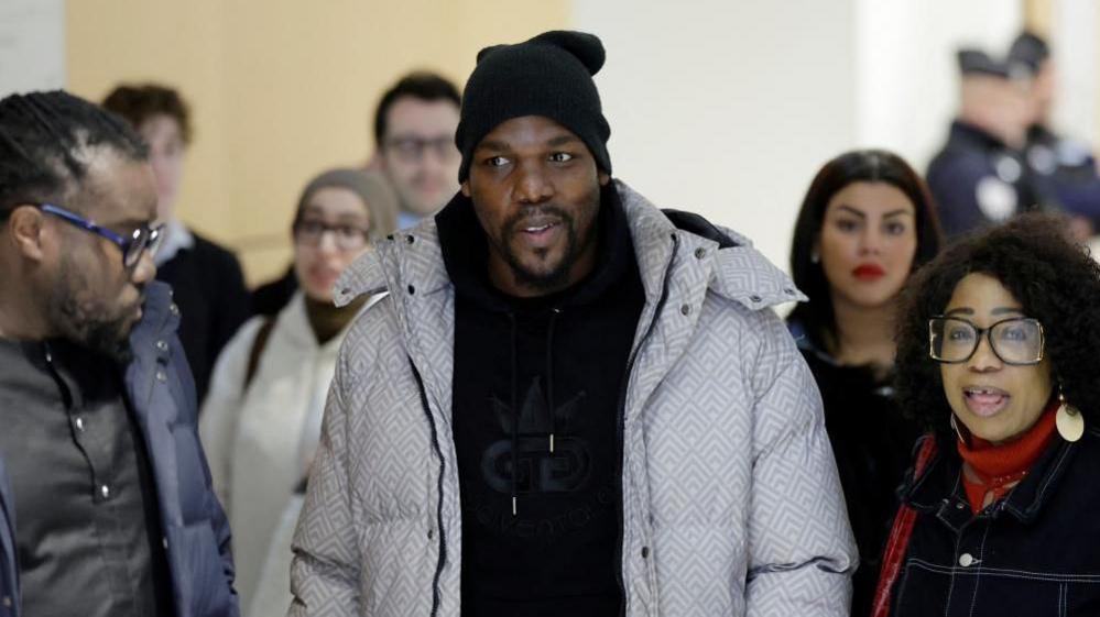 Mathias Pogba, brother of Paul Pogba, arrives at court in Paris with crowd of people around him