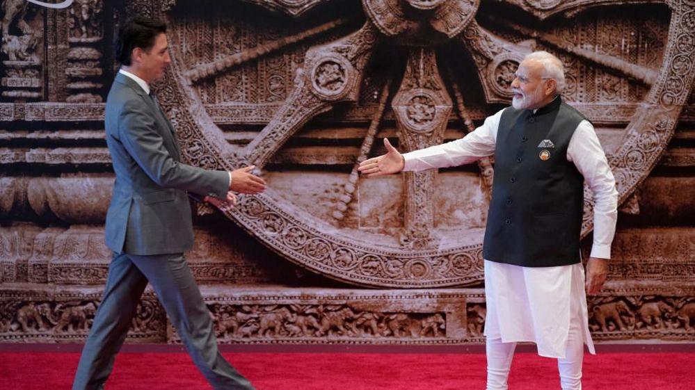 India's Prime Minister Narendra Modi (R) shakes hand with Canada's Prime Minister Justin Trudeau ahead of the G20 Leaders' Summit in New Delhi on September 9, 2023