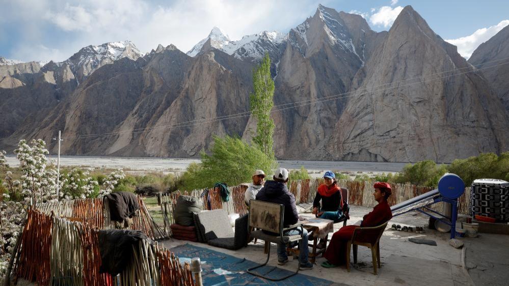 A micro observer officer designated to Ladakh's remote Warshi village, a polling station of five members, have a conversation with the relatives of the family members, ahead of the fifth phase of the general elections, in the Ladakh region, India, May 19, 2024. REUTERS/Sharafat Ali