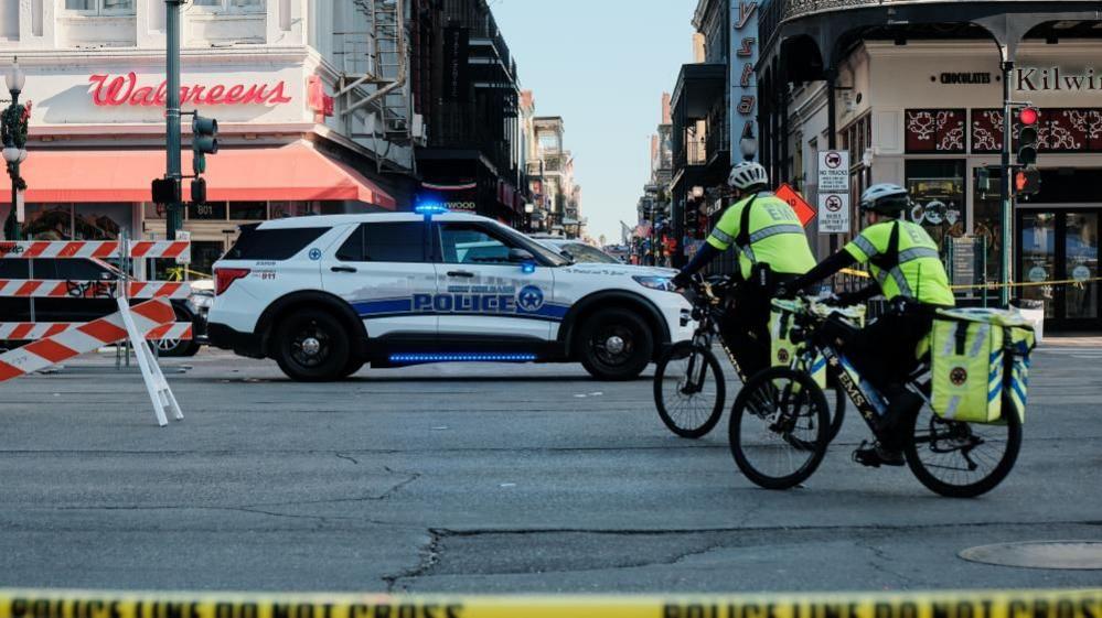 Police and paramedics in New Orleans after an army veteran was killed in a gunfight with police, after he drove a pick-up truck into crowds in the city on   New Year's Day