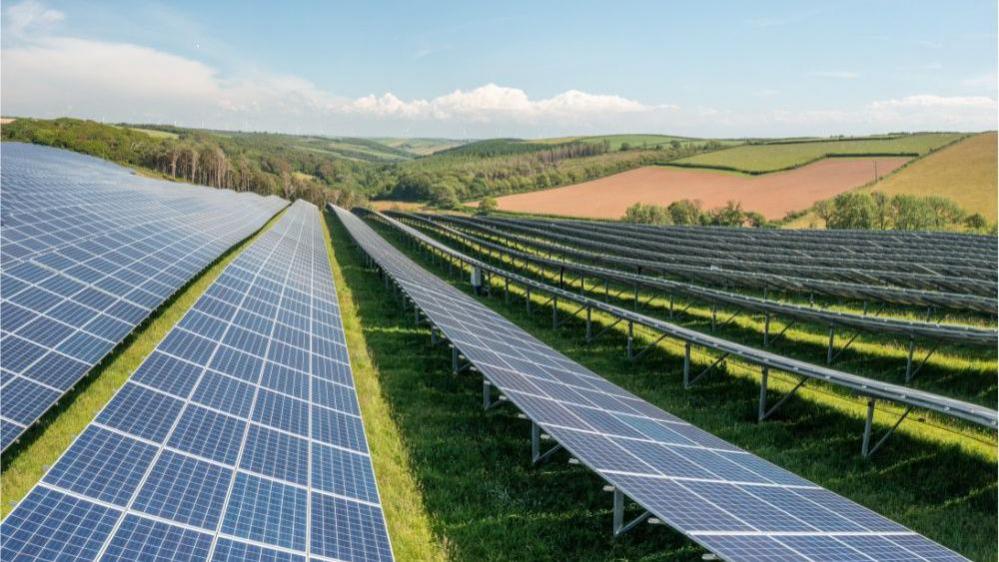 An image of an existing solar farm owned by BSR. Long rows of flat solar panels run across fields