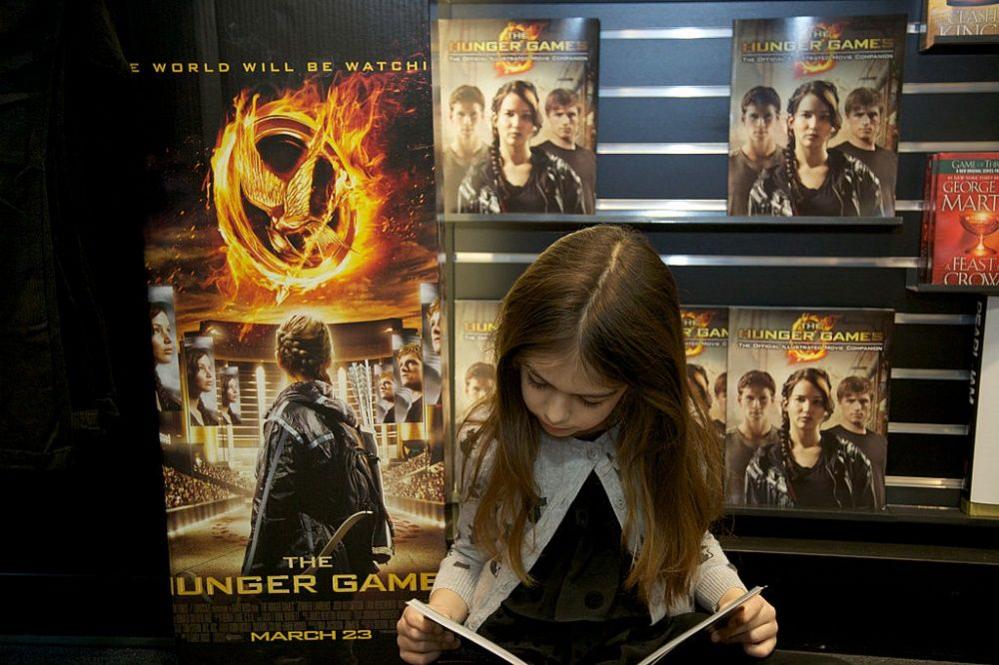 Girl reading Hunger Games book