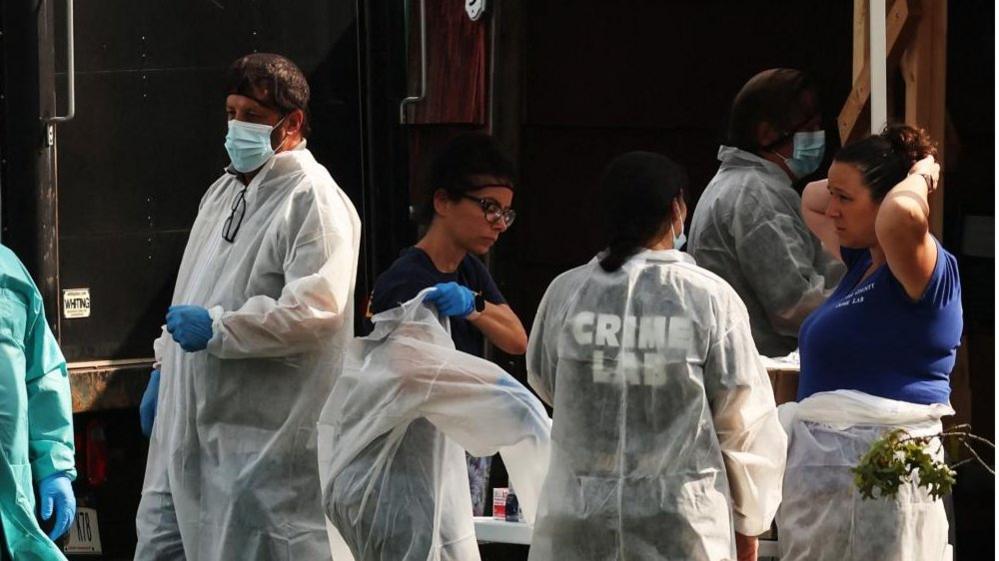 Investigators at the Heuermann home