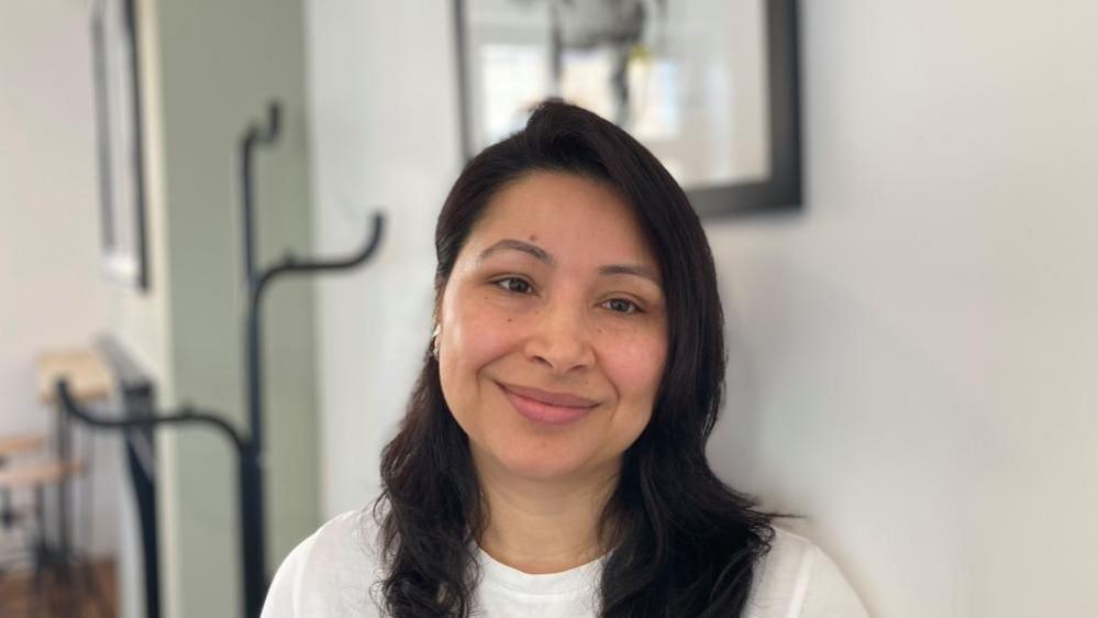 Mary Roka Magar with black hair and a white t-shirt