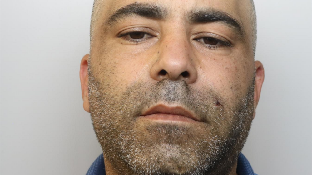 Sid Ali Djelid has a shaved head and dark stubble with specs of grey