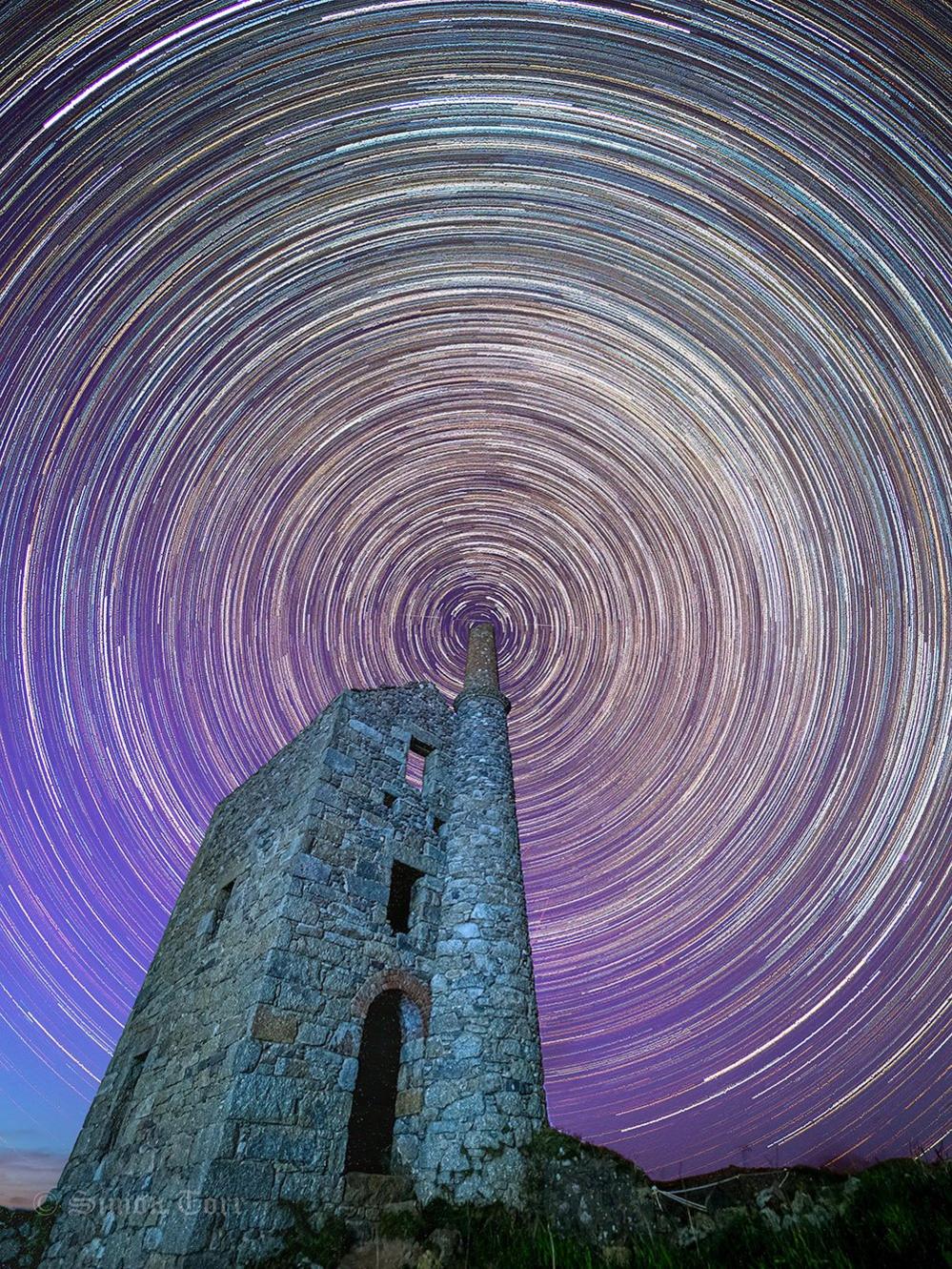 Star trails around an old tin mine building in Cornwall