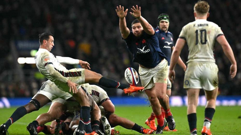 England scrum-half Alex Mitchell kicks the ball against France