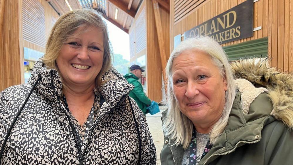 Tracey Kemp, 55, from Great Yarmouth in a black and white jacket and Roz Hazell, 58, from Great Yarmouth in a green jacket with a hood.
