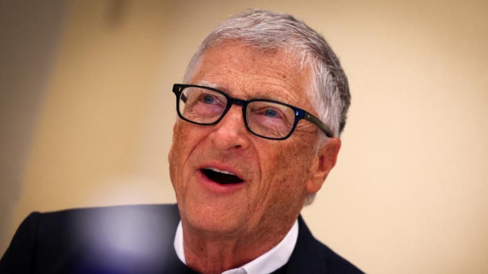 Bill Gates, who is wearing a jumper and has on his glasses, speaks to Reuters news agency on 8 May in in New York City