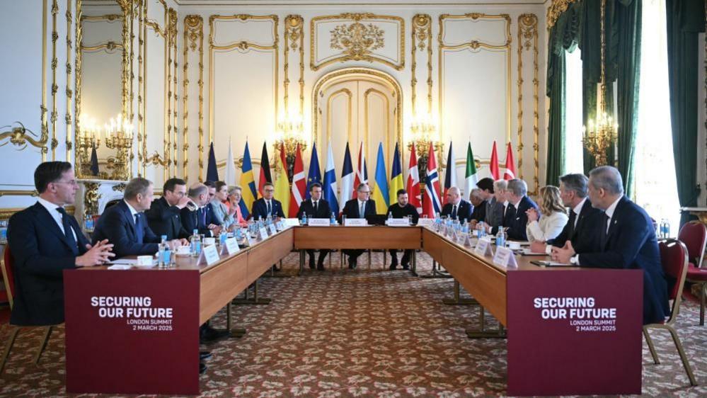 French President Emmanuel Macron, Prime Minister Sir Keir Starmer and Ukrainian President Volodymyr Zelensky, sit at the head of the table with other European leaders during a summit on the situation in Ukraine at Lancaster House, London