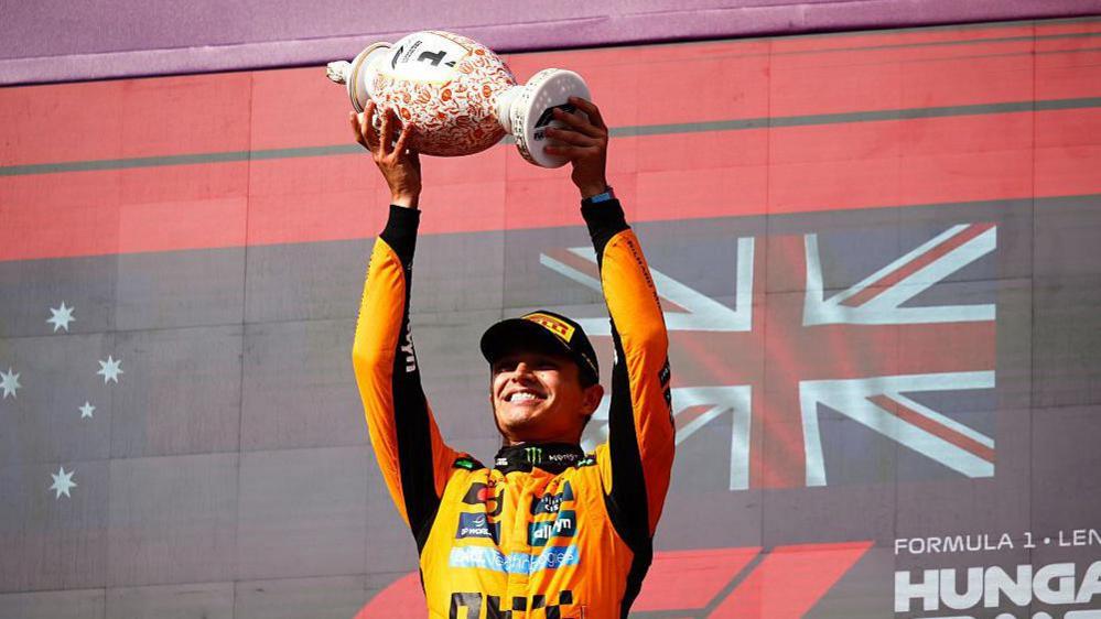 Lando Norris lifting the trophy on last year's Hungarian Grand Prix podium