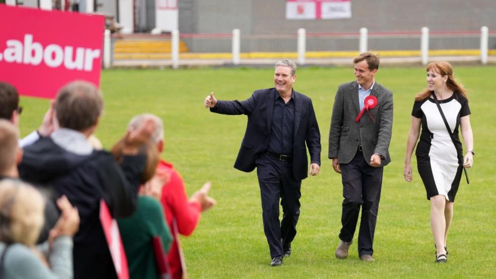 Keir Mather, centre, with Sir Keir Starmer and Angela Rayner celebrate at Selby Town